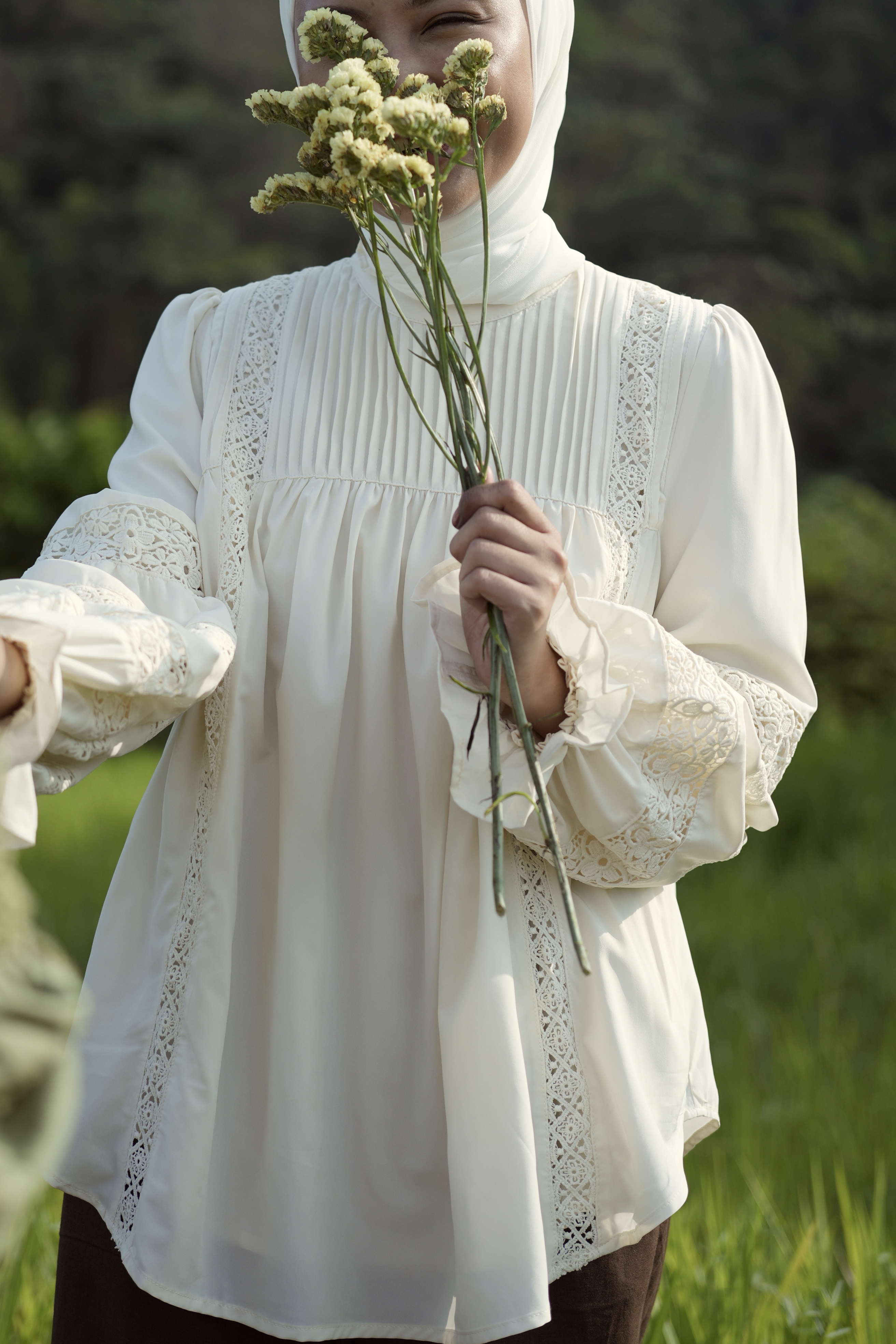 Paying homage to our Solange Kurung which made a debut this Eid - the Sonya Top is rendered in a pearly white, 100% soft and ultra lightweight fabric that features intricate pin-tucks at the bodice, floral inset lace detailing streaming down the bodice and at the puffed, bracelet-length sleeves.