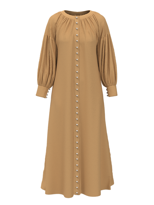 The Nour dress is an ode to the sandy dunes of the Arabian desert represented by the textured beige material and a reminiscent of our classic Eid ’22 Opal Kurung in beige.