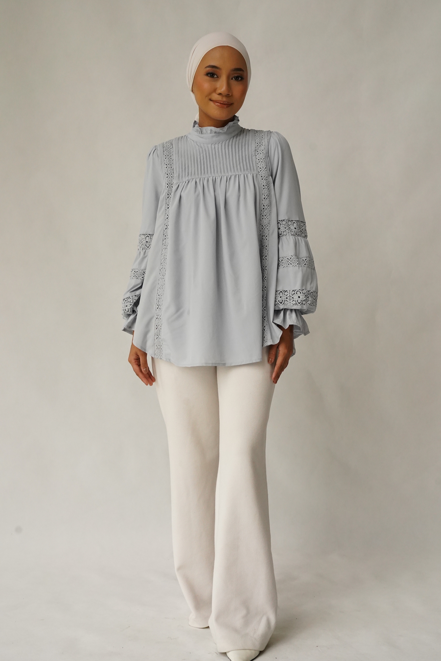 Paying homage to our Solange Kurung which made a debut this Eid - the Sonya Top is rendered in 100% soft, ultra lightweight matte polyester that features intricate pin-tucks at the bodice, floral inset lace detailing streaming down the bodice and at the puffed, bracelet-length sleeves. 
