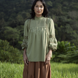 Paying homage to our Solange Kurung which made a debut this Eid - the Sonya Top is rendered in a hunter green, 100% soft and ultra lightweight fabric that features intricate pin-tucks at the bodice, floral inset lace detailing streaming down the bodice and at the puffed, bracelet-length sleeves.