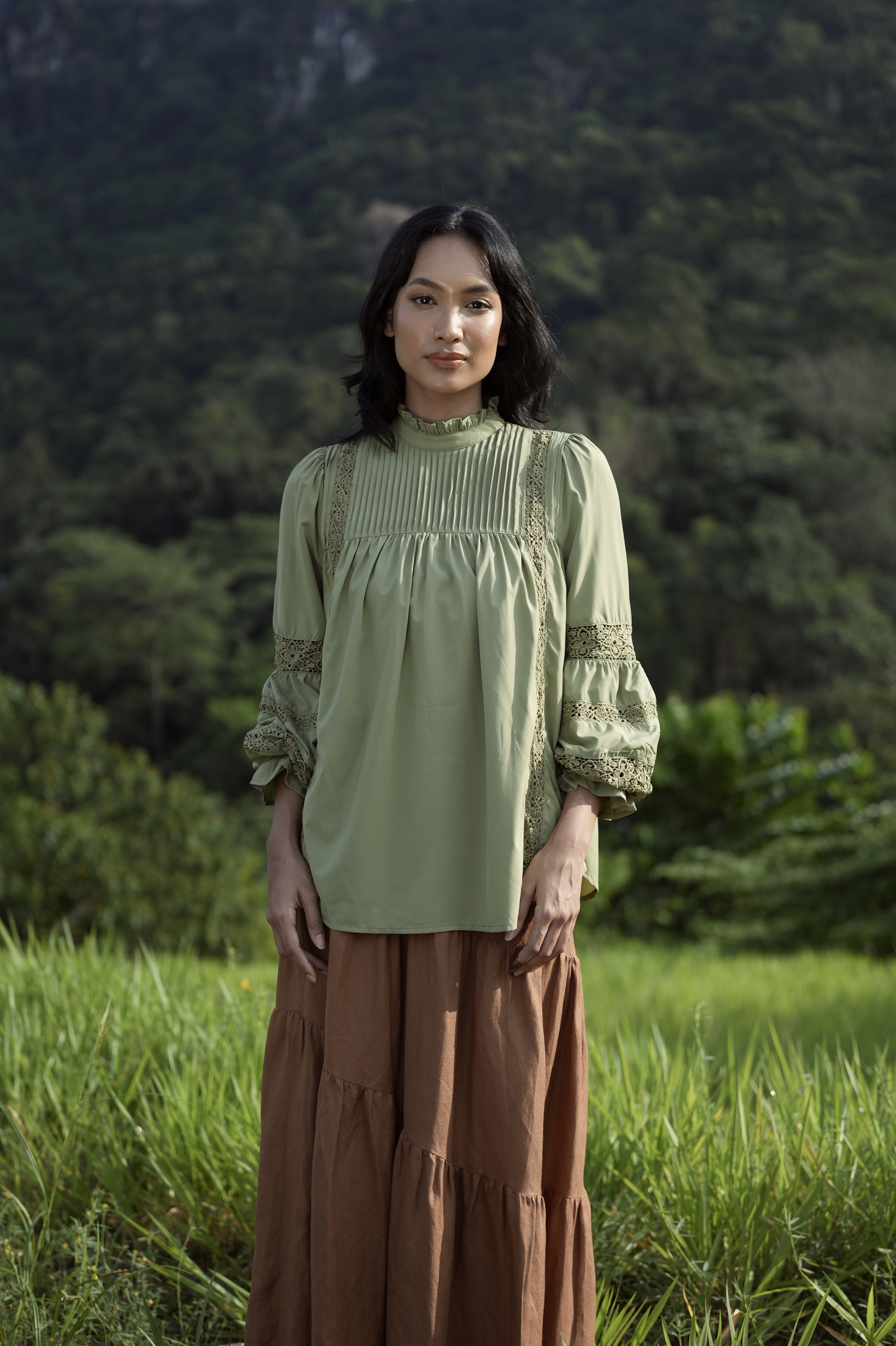 Paying homage to our Solange Kurung which made a debut this Eid - the Sonya Top is rendered in a hunter green, 100% soft and ultra lightweight fabric that features intricate pin-tucks at the bodice, floral inset lace detailing streaming down the bodice and at the puffed, bracelet-length sleeves.