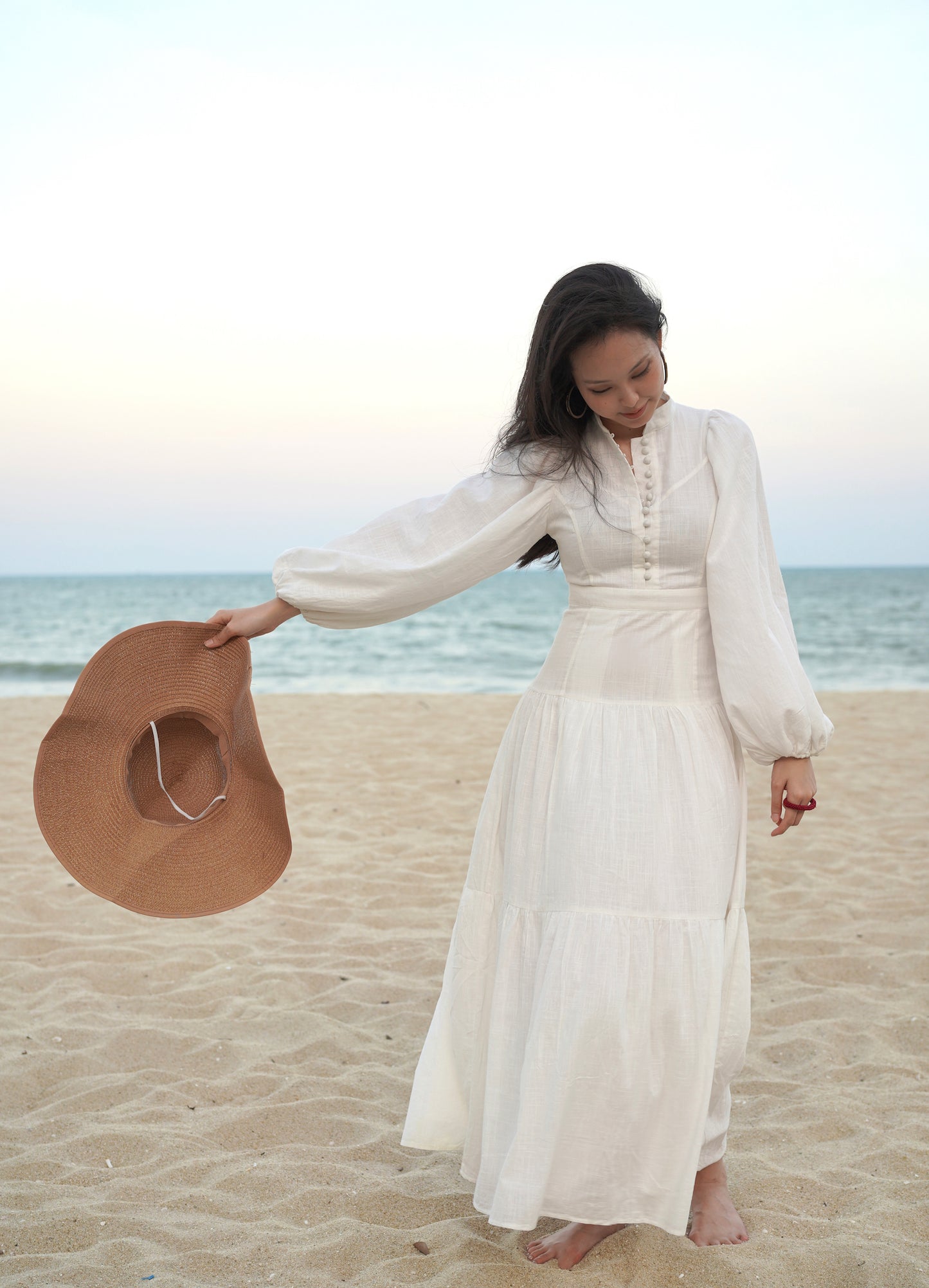 The Zora Opal dress in White is made in a dreamy linen with self-covered button-down delight, leading to a high-waist geometric patchwork, while the neckline is accented with a mandarin collar.